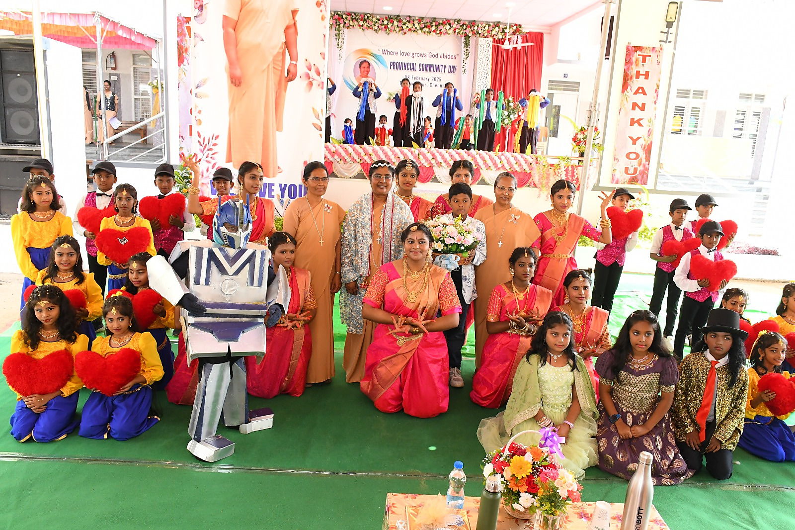 Students in costume with the Salesian Sisters at a school celebration