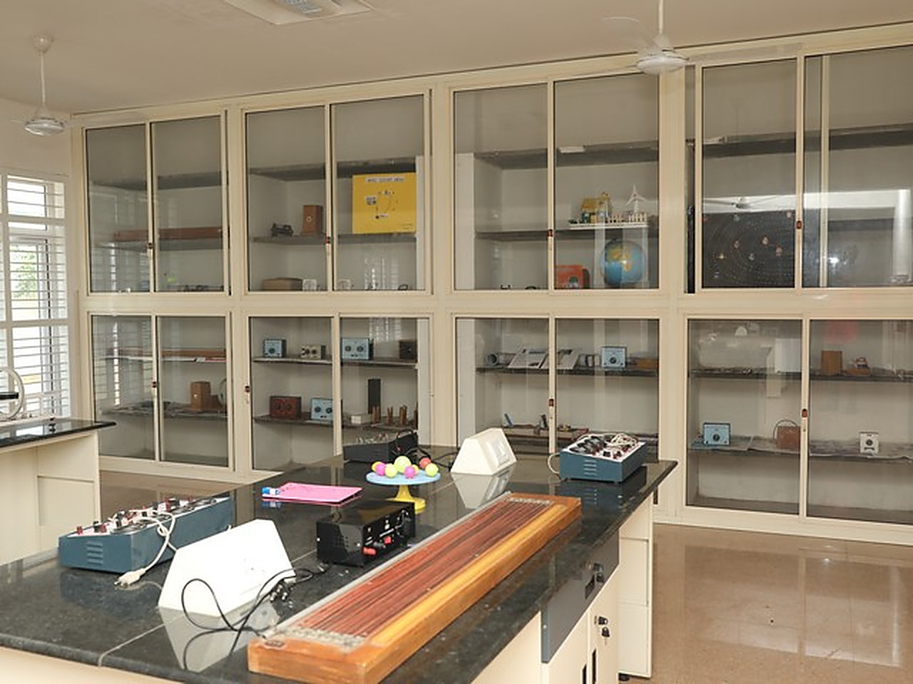 The physics laboratory, apparatus in glass-fronted cupboards