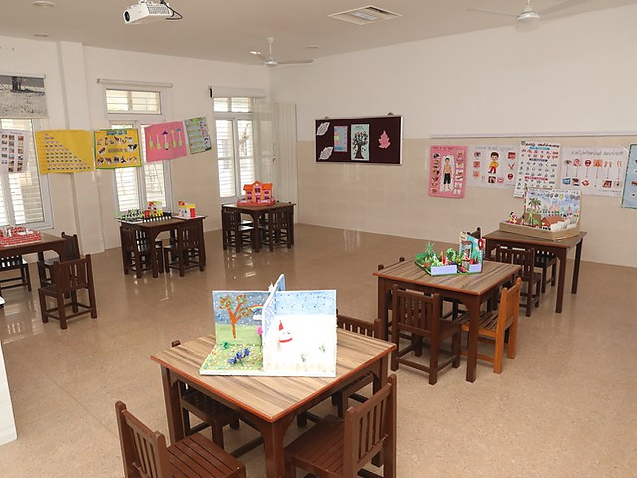 A kindergarten activity room, models and charts on every table