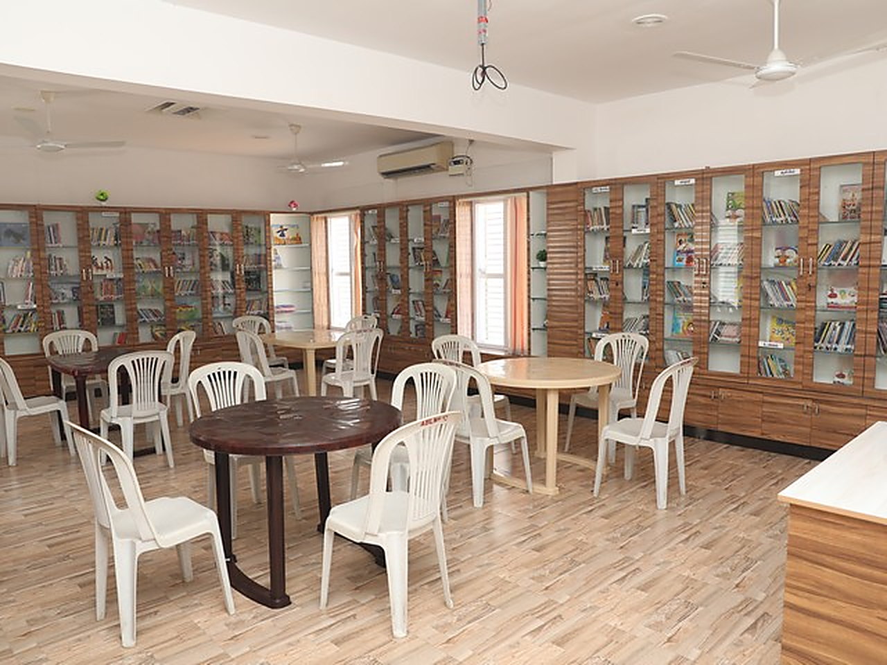 The library, lined with bookcases around reading tables